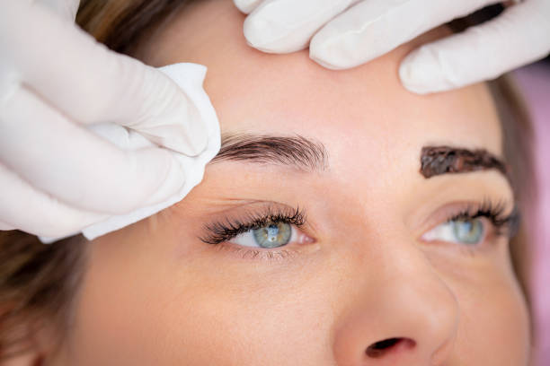 Beautician Cleaning Customer's Eyebrows from Hair Dye